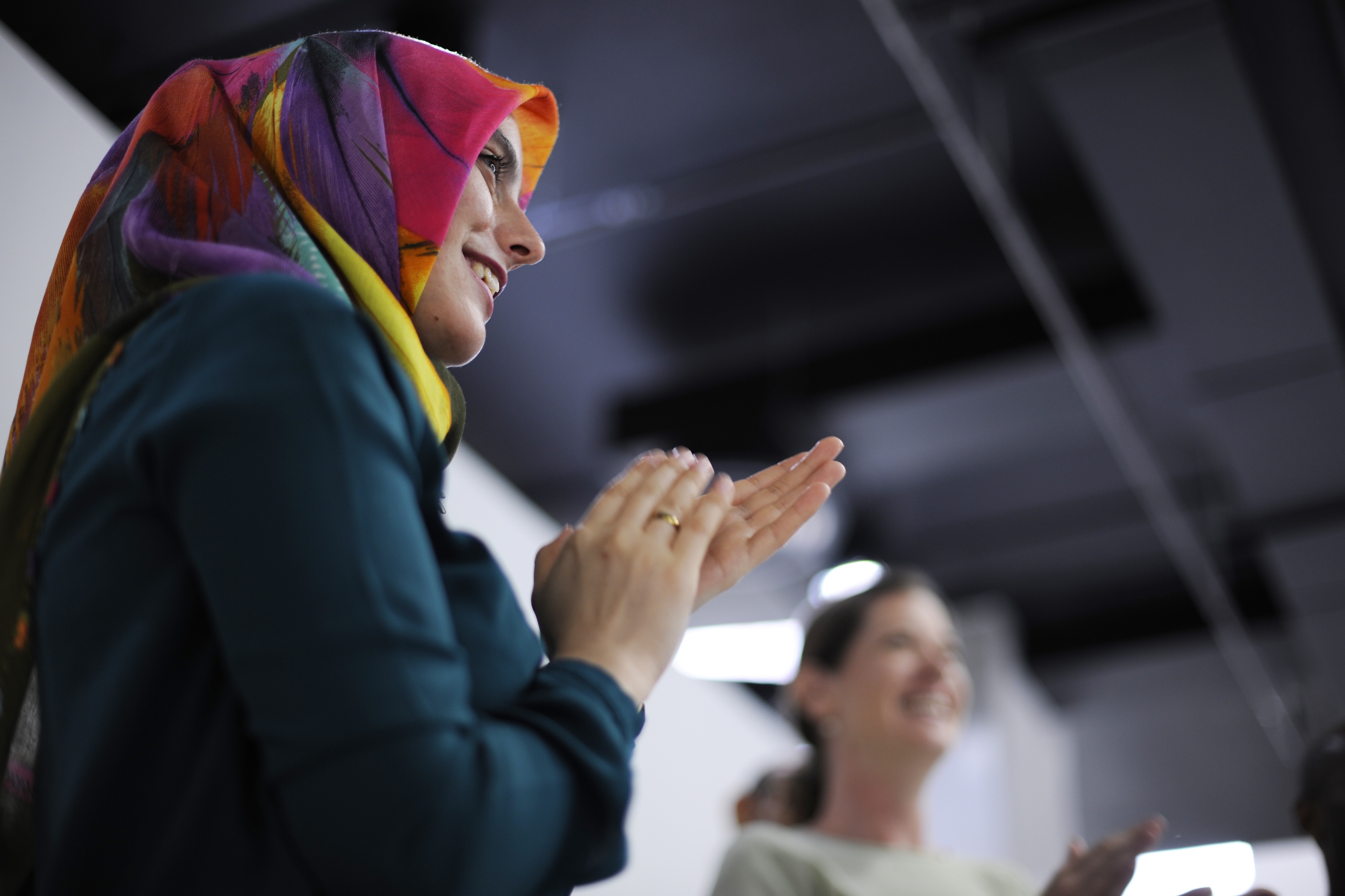 Woman With Headscarf Clapping - Global Solution Services (GSS)