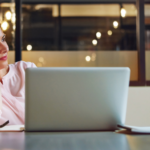 Women Staring Away While Sitting at Her Desk with Laptop Opened - Global Solution Services